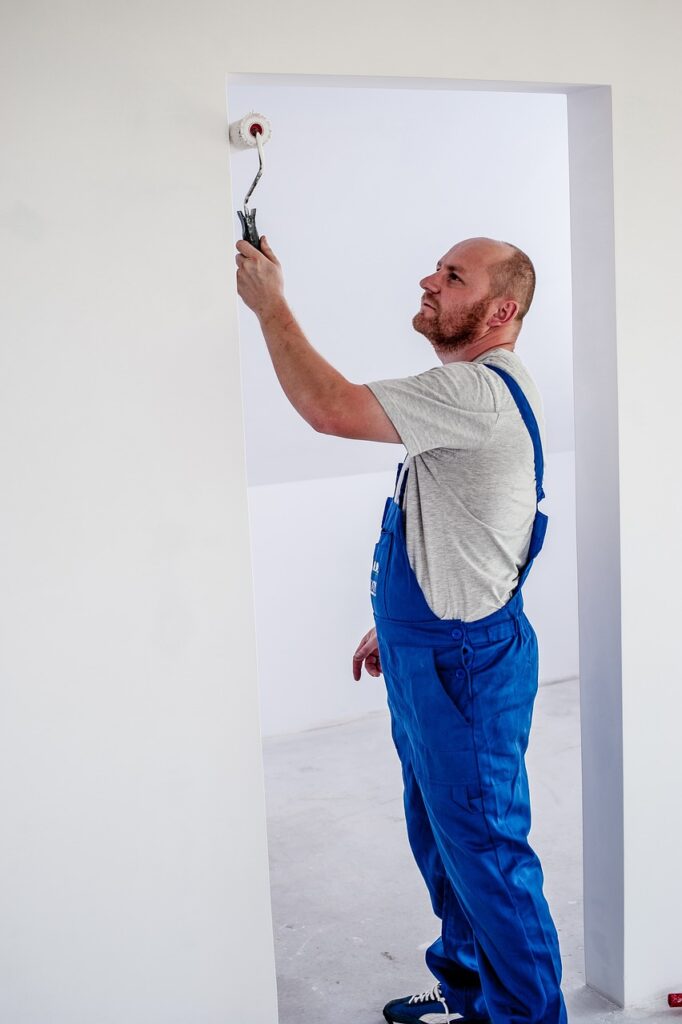 A painter in blue overalls